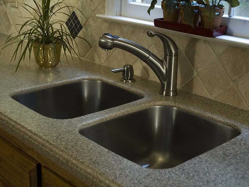 two separate sinks inset into counter tile backsplash