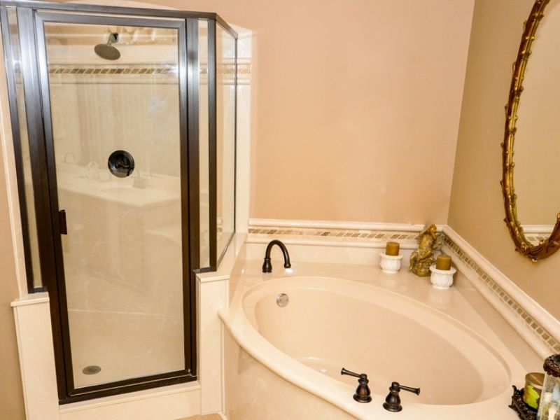 corner shower with brown trimmed door