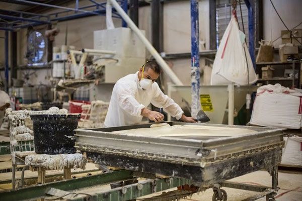 synmar employee performing cast stone forming before finishing