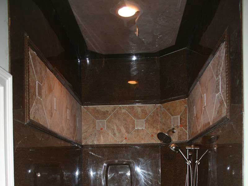 brown shower with decorated tile trim